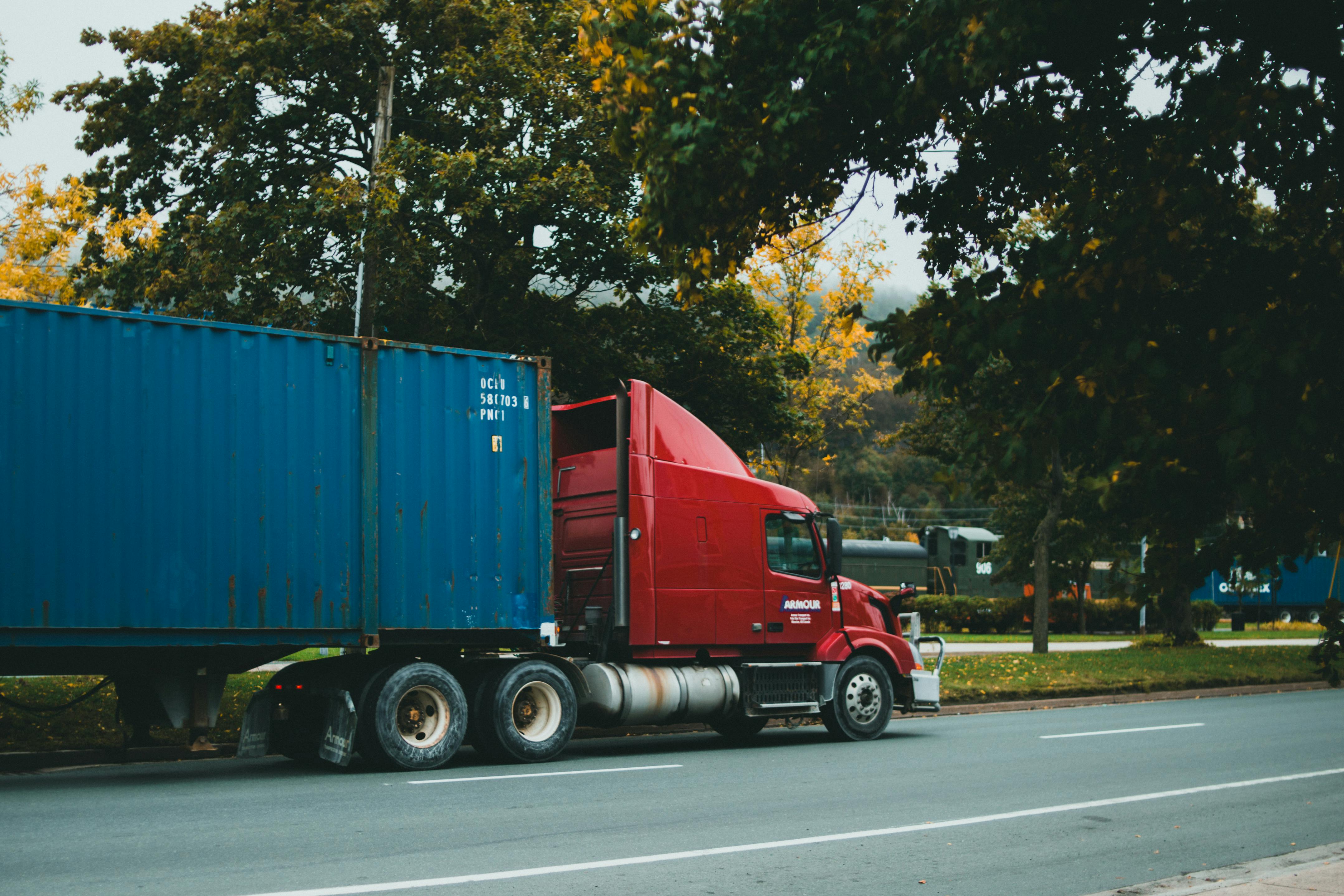 A truck on a highway at sunset